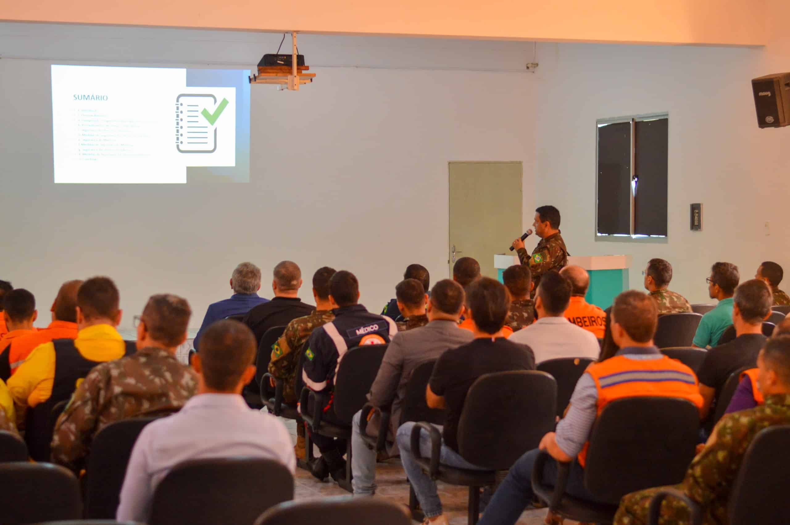 Palestra militar com projeção de apresentação na tela.