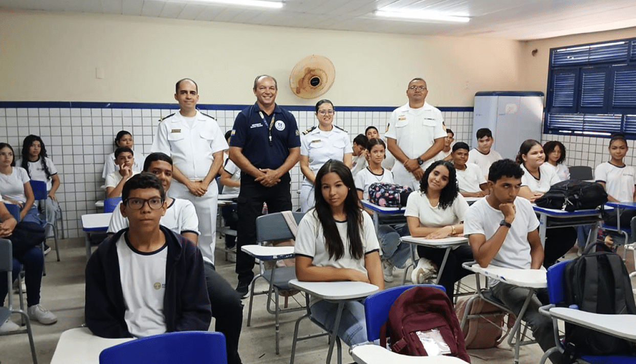Oficiais visitam alunos em sala de aula.
