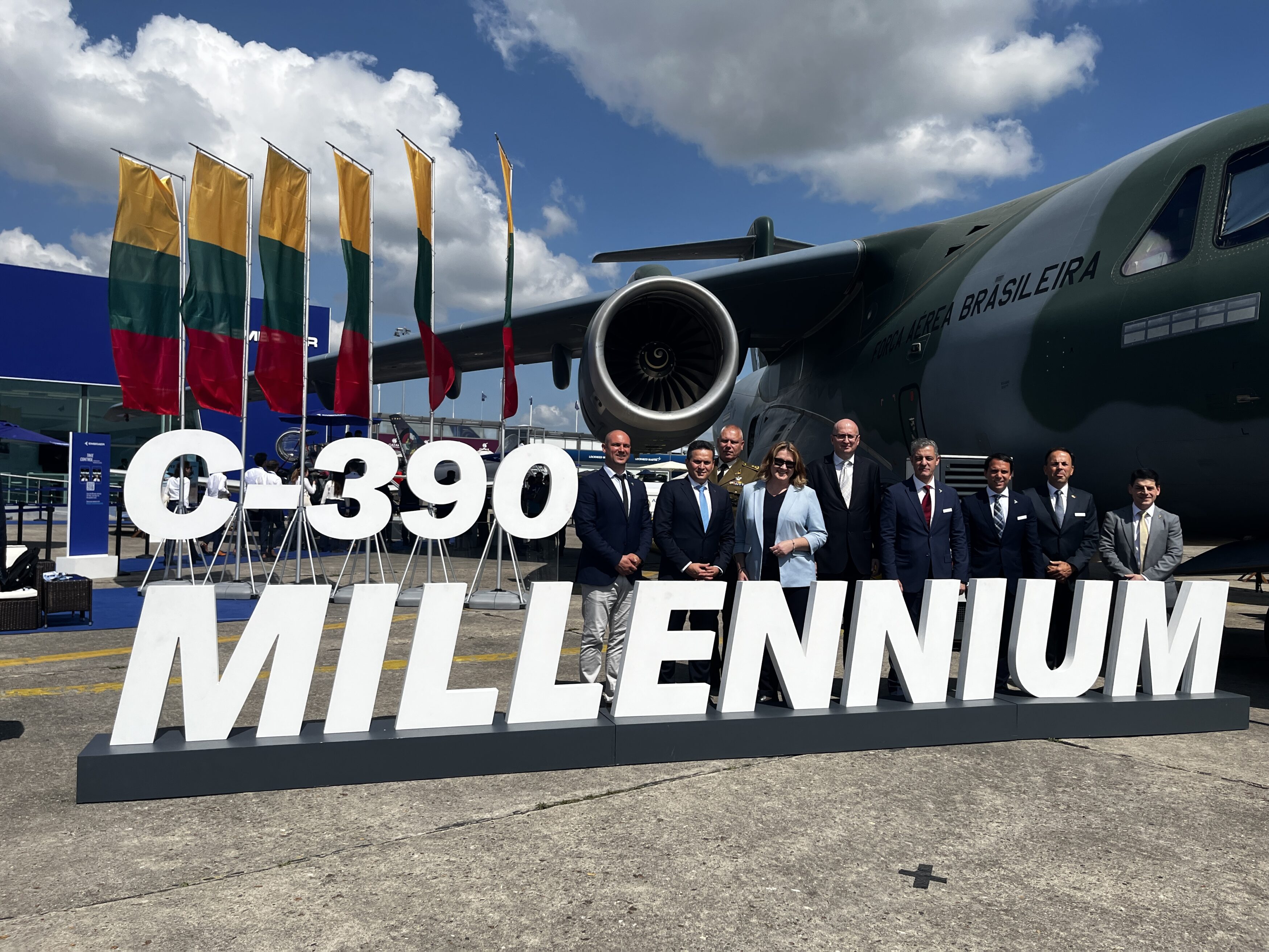 Avião militar C-390 Millennium com equipe em evento.