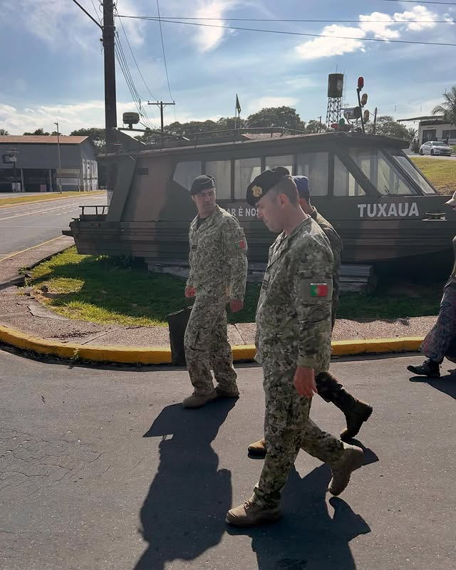 Soldados caminhando ao lado de embarcação Tuxaua.