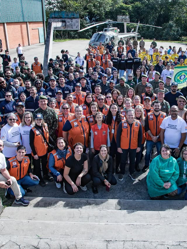 Equipe de emergência e helicóptero em operação conjunta.